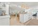 Open-concept kitchen features a large island, white cabinets, and seamless flow into the dining and living areas at 204 75Th St, Holmes Beach, FL 34217