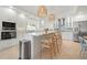 Modern kitchen with stainless steel appliances, white cabinetry, and island seating, perfect for entertaining at 204 75Th St, Holmes Beach, FL 34217