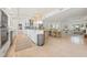 Spacious kitchen features white cabinets, island with seating, and flows into the adjacent dining and living areas at 204 75Th St, Holmes Beach, FL 34217