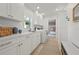 Well-organized laundry room features modern appliances and ample storage space, with a view to a bedroom at 204 75Th St, Holmes Beach, FL 34217