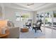 Bright living room with wicker chairs and sliding glass doors to the patio at 204 75Th St, Holmes Beach, FL 34217