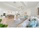 Bright and airy living room with open floor plan, modern furnishings, and seamless flow to dining area at 204 75Th St, Holmes Beach, FL 34217