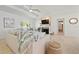 Bright living room featuring tray ceilings, a cozy fireplace, large windows, and stylish neutral furniture at 204 75Th St, Holmes Beach, FL 34217