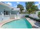 Backyard featuring a private in-ground pool surrounded by a white fence and lush landscaping at 204 75Th St, Holmes Beach, FL 34217
