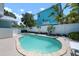 Backyard featuring a private in-ground pool surrounded by a white fence and lush landscaping at 204 75Th St, Holmes Beach, FL 34217