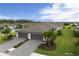 Beautiful new construction home featuring a three car garage, paver driveway, and lush tropical landscaping at 2193 Bonito Way, Port Charlotte, FL 33953