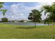 Scenic view of the lake with lush greenery in a peaceful community at 2193 Bonito Way, Port Charlotte, FL 33953