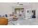 Comfortable living room with a large sectional sofa, a ceiling fan, and sliding glass doors for natural light at 2193 Bonito Way, Port Charlotte, FL 33953
