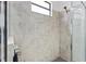 Modern shower with gray tile and glass door featuring a shower head and faucet at 2193 Bonito Way, Port Charlotte, FL 33953