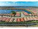 An aerial view of a community with well-manicured lawns and a beautiful lake at 224 Soliera St, Nokomis, FL 34275