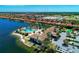 Beautiful aerial view of community pool, clubhouse, lakefront homes, and lush landscaping on a sunny day at 224 Soliera St, Nokomis, FL 34275