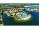 Community clubhouse, pool, and tennis courts surrounded by beautiful landscaping and lake views at 224 Soliera St, Nokomis, FL 34275