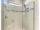 Modern bathroom featuring a glass shower with gray tiling and multiple shower heads at 224 Soliera St, Nokomis, FL 34275