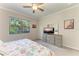 Bedroom featuring a ceiling fan, dresser and a window with lush greenery views at 224 Soliera St, Nokomis, FL 34275
