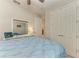 Bright bedroom with a large window and ceiling fan, featuring a plush bed and ample closet space at 224 Soliera St, Nokomis, FL 34275