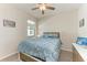 Cozy bedroom featuring a queen bed, ceiling fan, and a window with natural light at 224 Soliera St, Nokomis, FL 34275