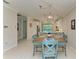 Bright dining room with an adjacent kitchen, neutral walls and light flooring at 224 Soliera St, Nokomis, FL 34275