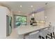 Bright, modern kitchen with stainless steel appliances, quartz countertops, and bar stool seating at 224 Soliera St, Nokomis, FL 34275