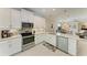 Well-equipped kitchen with stainless steel appliances, light countertops, and tile backsplash at 224 Soliera St, Nokomis, FL 34275