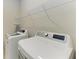 Well-equipped laundry room featuring a washer, dryer, and shelving at 224 Soliera St, Nokomis, FL 34275
