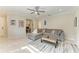 Spacious living room with a sectional sofa, natural light, and tile floors at 224 Soliera St, Nokomis, FL 34275