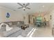 Bright and airy living room with a gray sectional sofa and tile flooring at 224 Soliera St, Nokomis, FL 34275