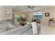Open-concept living room with a large gray sectional sofa and view of the backyard at 224 Soliera St, Nokomis, FL 34275