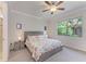 Bedroom with a ceiling fan and a large window showcasing the outdoor landscape at 224 Soliera St, Nokomis, FL 34275