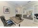 Office space with a comfortable chair and a desk with two monitors, featuring a view into the living room at 224 Soliera St, Nokomis, FL 34275