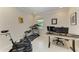 Home office with a desk, computer setup, exercise bike, and treadmill at 224 Soliera St, Nokomis, FL 34275