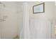 Bathroom with a white shower with shower curtain, neutral walls and fixtures at 2551 Waneta Dr, Sarasota, FL 34231