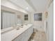 Bright bathroom featuring a long countertop, drawers and a large mirror at 2551 Waneta Dr, Sarasota, FL 34231