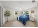 Cozy bedroom with a blue comforter and white walls, filled with natural light from two windows at 2551 Waneta Dr, Sarasota, FL 34231