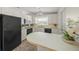 Functional kitchen with white cabinets, tile floors, and a breakfast bar at 2551 Waneta Dr, Sarasota, FL 34231