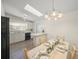 Open-concept kitchen and dining area with white cabinets, tile floors, and a skylight at 2551 Waneta Dr, Sarasota, FL 34231
