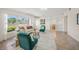 Inviting living room with neutral colors, tile flooring, and views into the dining area at 2551 Waneta Dr, Sarasota, FL 34231
