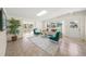 Bright living room with tile flooring, large windows, skylight, and comfortable seating arrangement at 2551 Waneta Dr, Sarasota, FL 34231