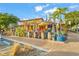 Outdoor patio dining area of a restaurant with colorful decor and lush greenery at 2551 Waneta Dr, Sarasota, FL 34231