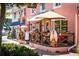 Charming cafe exterior with umbrella-covered patio, American and French flags, and floral accents at 2551 Waneta Dr, Sarasota, FL 34231