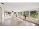 Bright sunroom filled with natural light, featuring tile flooring and a cozy seating area at 2551 Waneta Dr, Sarasota, FL 34231