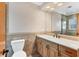 Bathroom features a wood vanity and a large mirror with shower in the background at 3072 Meyer Dr, Sarasota, FL 34239