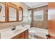 Bathroom with vanity, matching mirror, bathtub, and tiled shower at 3072 Meyer Dr, Sarasota, FL 34239