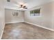 Bedroom boasts tile flooring, ceiling fan, and neutral paint at 3072 Meyer Dr, Sarasota, FL 34239