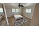Cozy bedroom with neutral paint, tiled flooring, and a ceiling fan at 3072 Meyer Dr, Sarasota, FL 34239