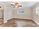 Neutral bedroom with tile floors, crown molding, and a large window, offering ample natural light at 3072 Meyer Dr, Sarasota, FL 34239