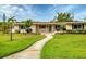 Charming single-story home with manicured lawn and walkway leading to the front door at 3072 Meyer Dr, Sarasota, FL 34239