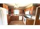 Traditional kitchen featuring wood cabinets, tiled backsplash, and white appliances, with a window over the sink at 3072 Meyer Dr, Sarasota, FL 34239