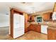 Well-lit kitchen featuring wooden cabinets, granite countertops, tile floors, and modern white appliances at 3072 Meyer Dr, Sarasota, FL 34239