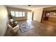 Bright living room with tile flooring, neutral paint, shuttered window, and an open doorway at 3072 Meyer Dr, Sarasota, FL 34239