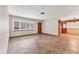 Open living room with large windows, tile floors, and view of the adjacent dining area at 3072 Meyer Dr, Sarasota, FL 34239